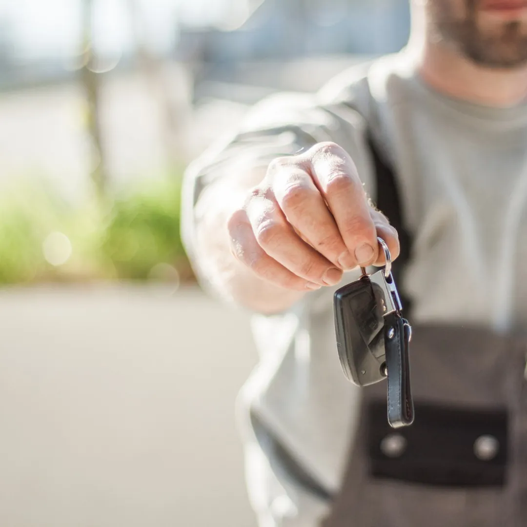 Locksmith handing over a newly programmed car key fob in Montgomery, AL Locksmith handing over a newly programmed car key fob in Montgomery, AL